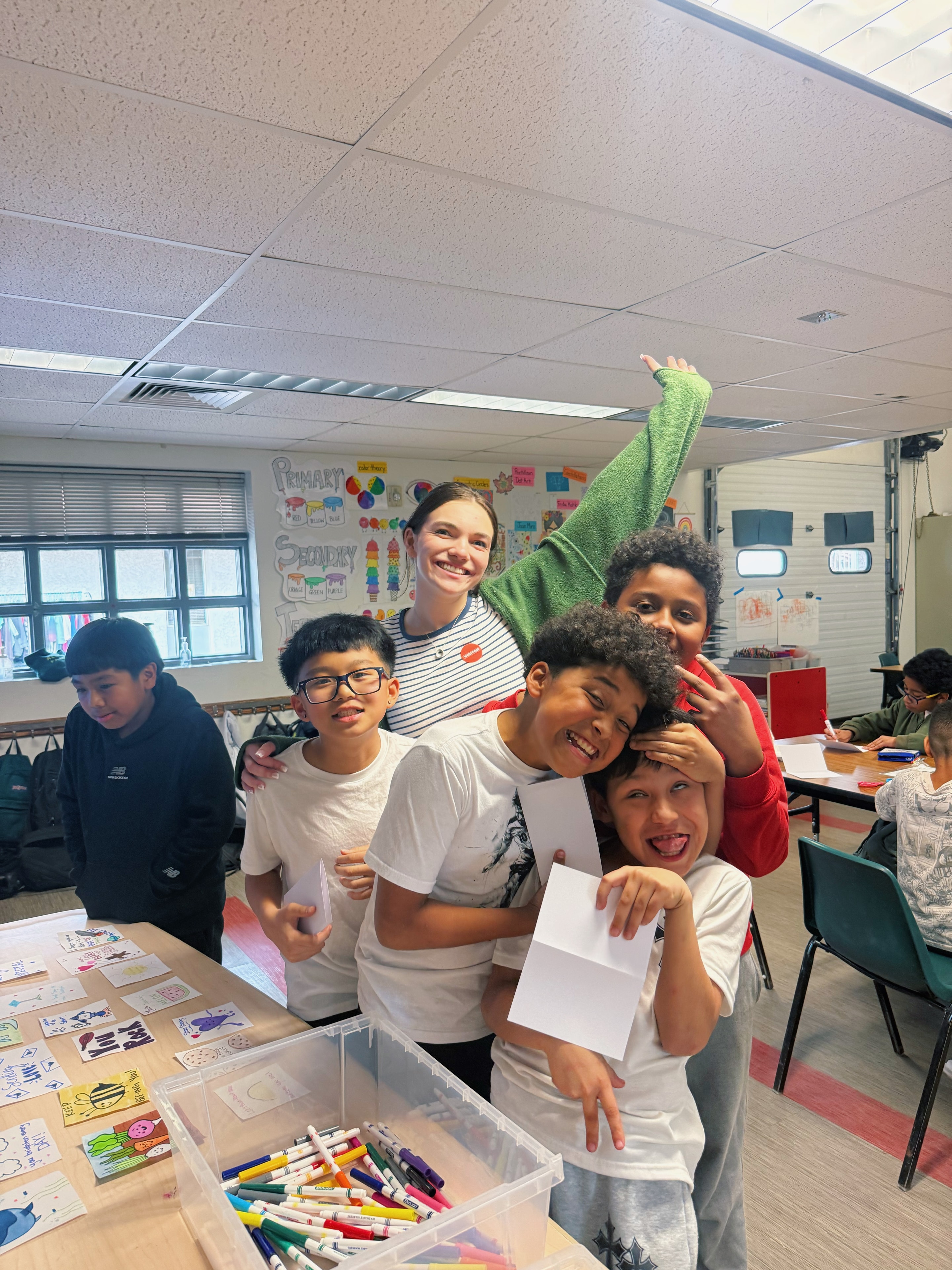 Teacher and students celebrating in classroom